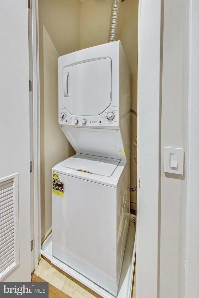 washroom with stacked washer / drying machine