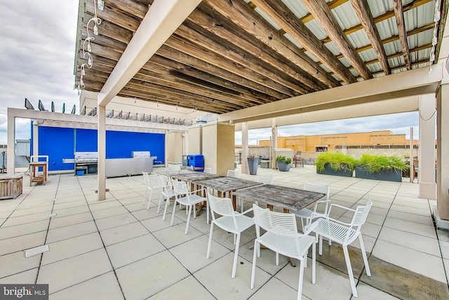 view of patio with an outdoor living space and a grill