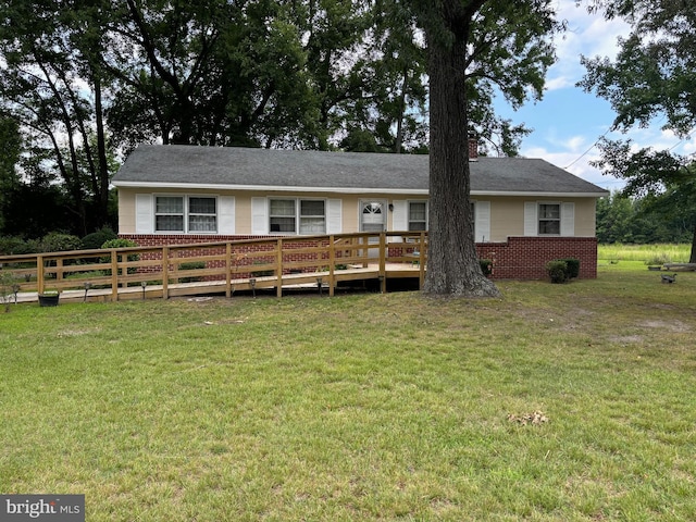 ranch-style house featuring a front yard and a deck