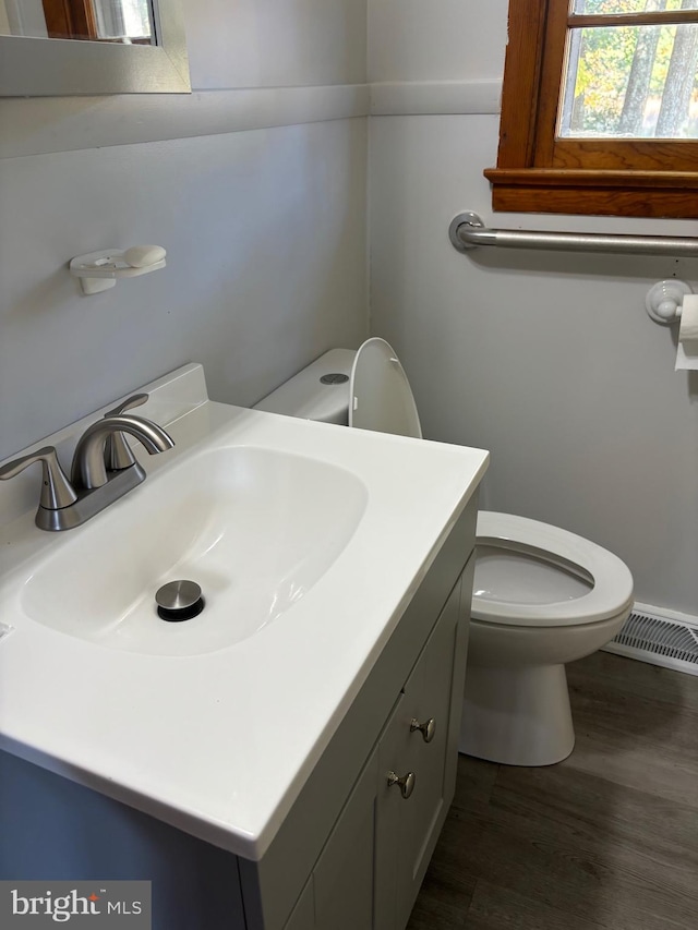 bathroom with vanity, hardwood / wood-style floors, and toilet