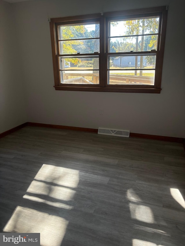 empty room with dark wood-type flooring