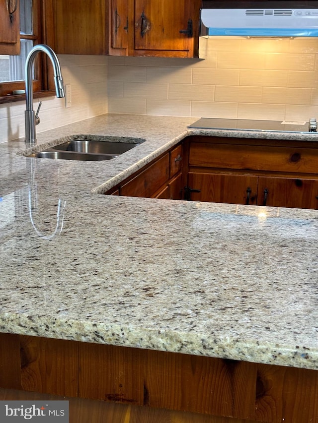 kitchen featuring sink, backsplash, exhaust hood, and black electric cooktop