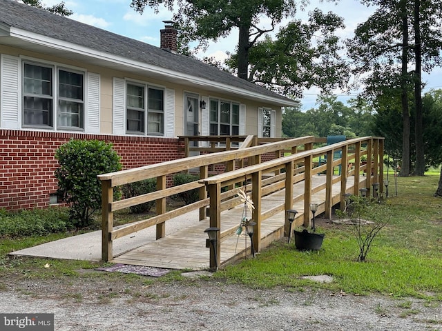 view of property's community with a wooden deck and a lawn