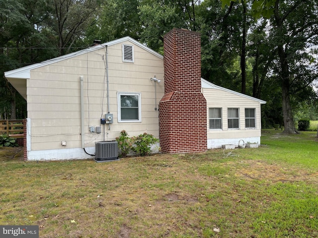 exterior space featuring a lawn and cooling unit