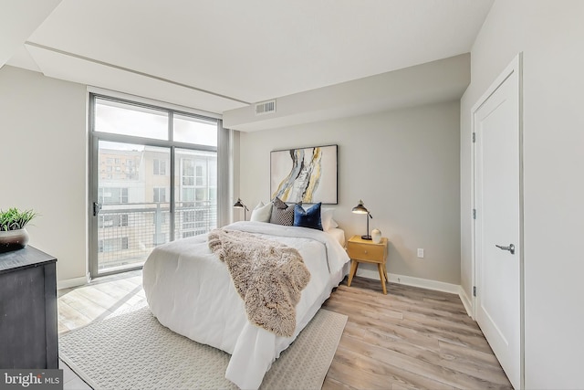 bedroom featuring access to exterior and light hardwood / wood-style floors