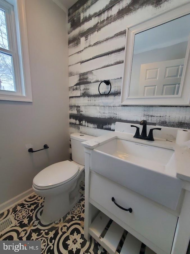 bathroom featuring tile patterned flooring, vanity, and toilet