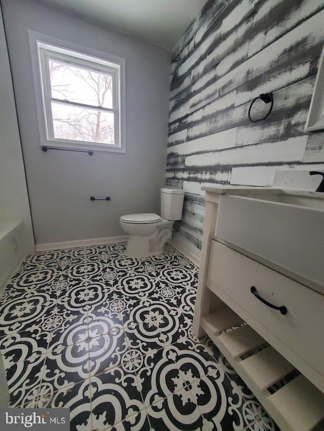 bathroom featuring tile patterned flooring, vanity, and toilet