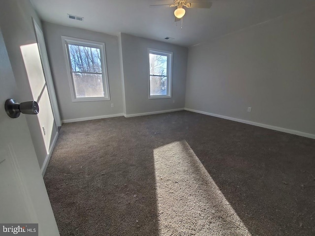 carpeted empty room featuring ceiling fan