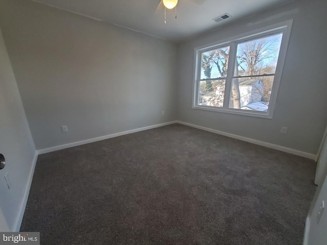 carpeted spare room with ceiling fan