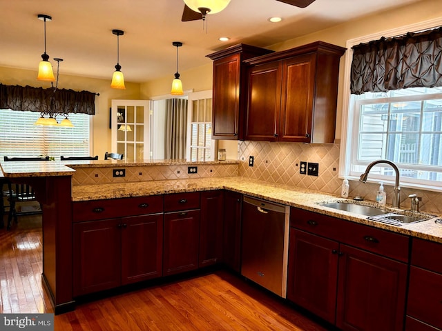 kitchen with kitchen peninsula, dishwasher, decorative backsplash, and light wood-type flooring