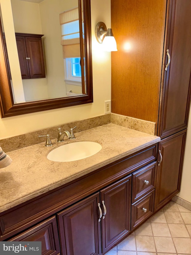 bathroom featuring tile patterned flooring and vanity