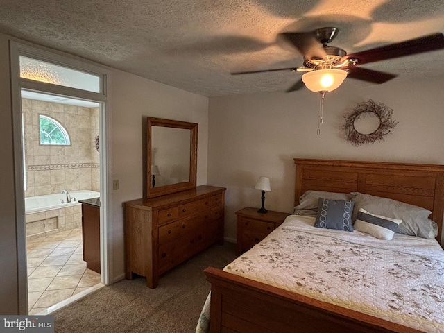 bedroom with carpet, ensuite bathroom, a textured ceiling, and ceiling fan