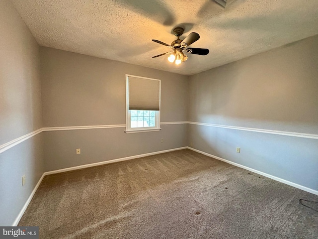 carpeted spare room featuring ceiling fan and a textured ceiling