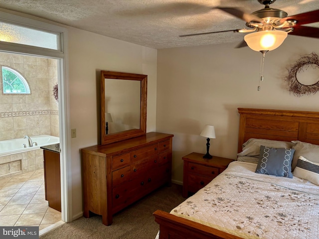 tiled bedroom with ceiling fan and a textured ceiling