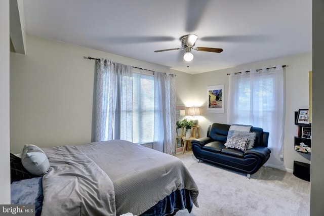 carpeted bedroom featuring ceiling fan and multiple windows