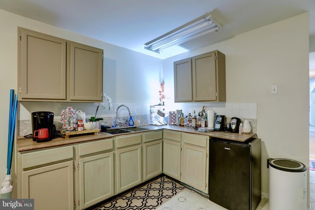 kitchen with light tile patterned floors, backsplash, and sink