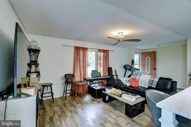 living room featuring ceiling fan, hardwood / wood-style floors, and a healthy amount of sunlight