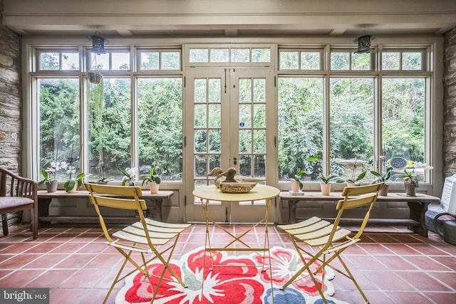 sunroom featuring a healthy amount of sunlight and french doors