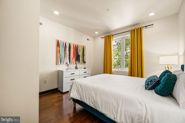 bedroom with dark wood-type flooring