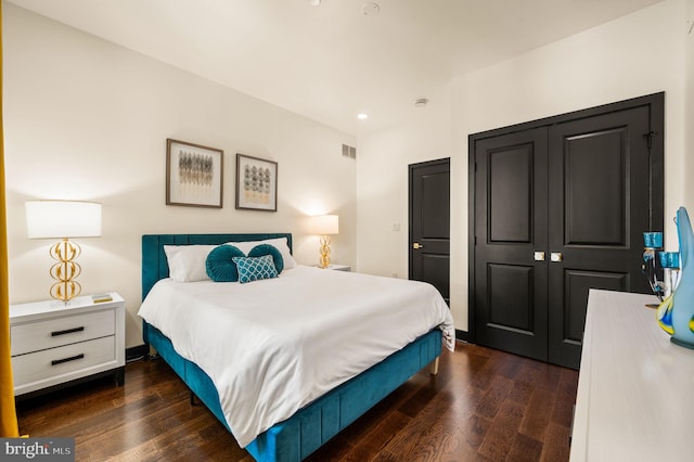 bedroom featuring a closet and dark wood-type flooring