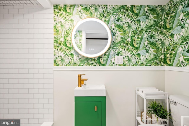 bathroom featuring vanity and toilet