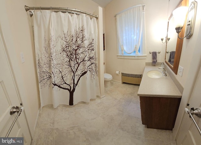 bathroom featuring toilet, vanity, and radiator heating unit