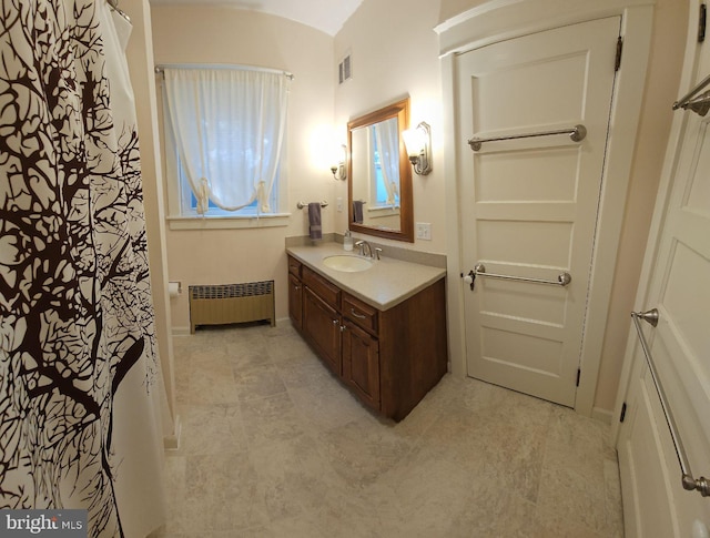 bathroom with vanity and radiator heating unit