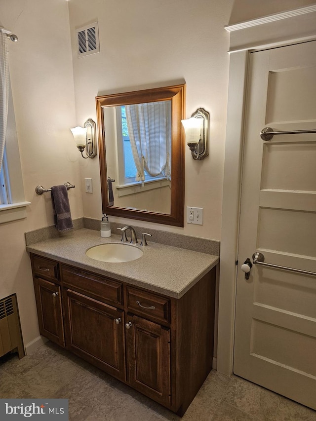 bathroom with vanity and radiator