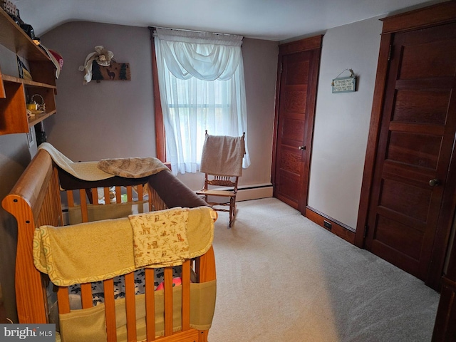 bedroom with light colored carpet, vaulted ceiling, and a baseboard heating unit