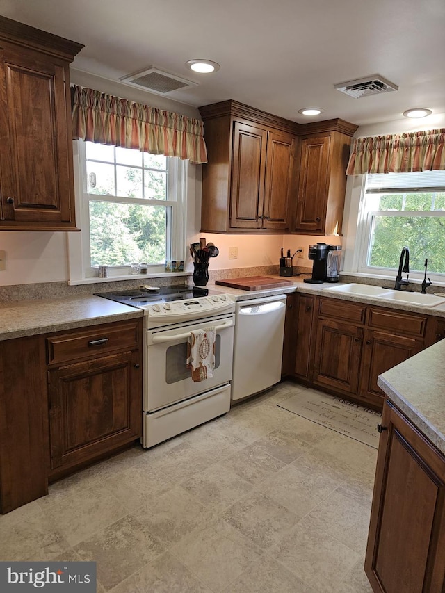 kitchen with white appliances and sink