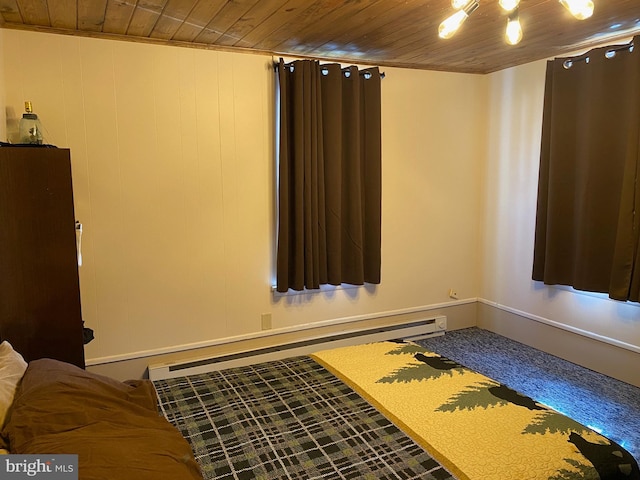 unfurnished bedroom with a baseboard radiator and wood ceiling