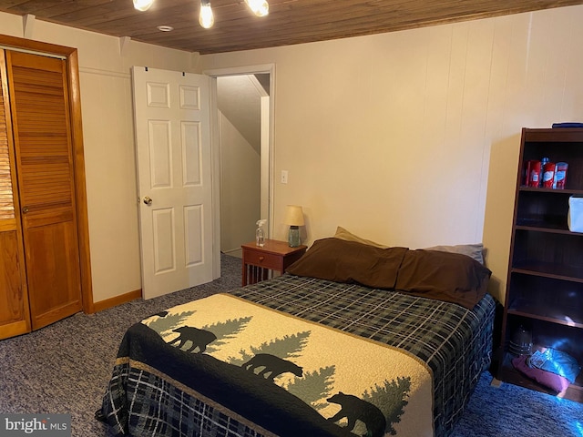 carpeted bedroom with a closet and wooden ceiling