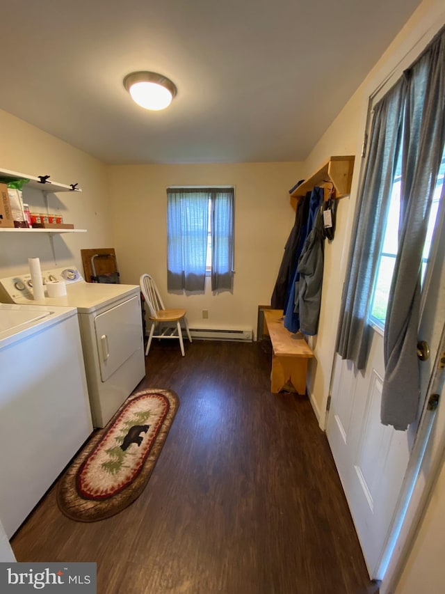 laundry area with laundry area, dark wood-type flooring, baseboards, baseboard heating, and washer and clothes dryer