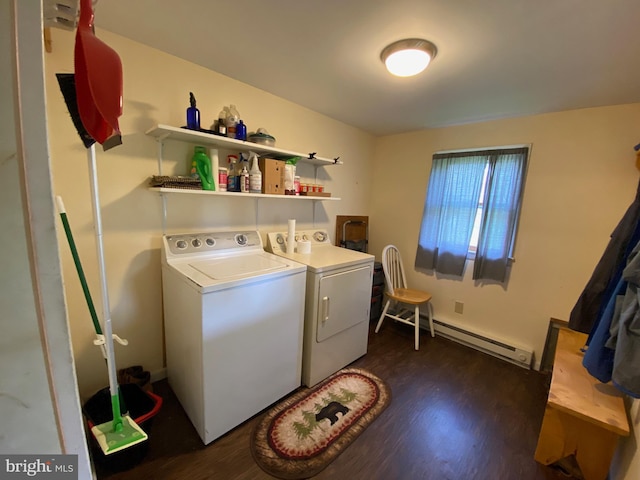 laundry room with laundry area, baseboard heating, dark wood-type flooring, and washing machine and clothes dryer