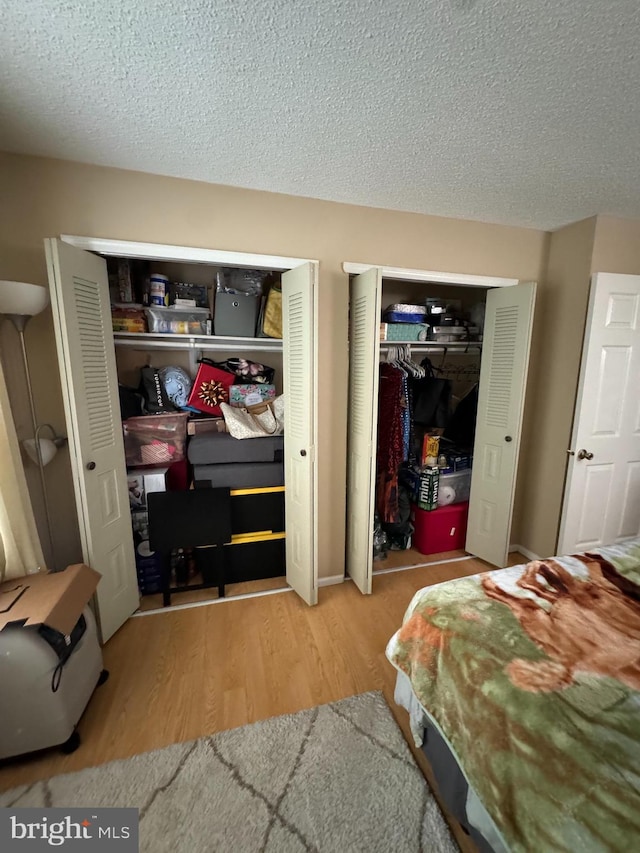 bedroom with wood-type flooring and a textured ceiling