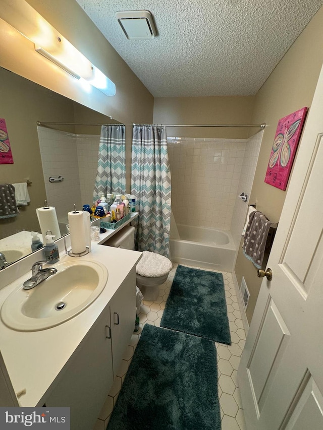 full bathroom featuring a textured ceiling, vanity, shower / bath combination with curtain, tile patterned flooring, and toilet