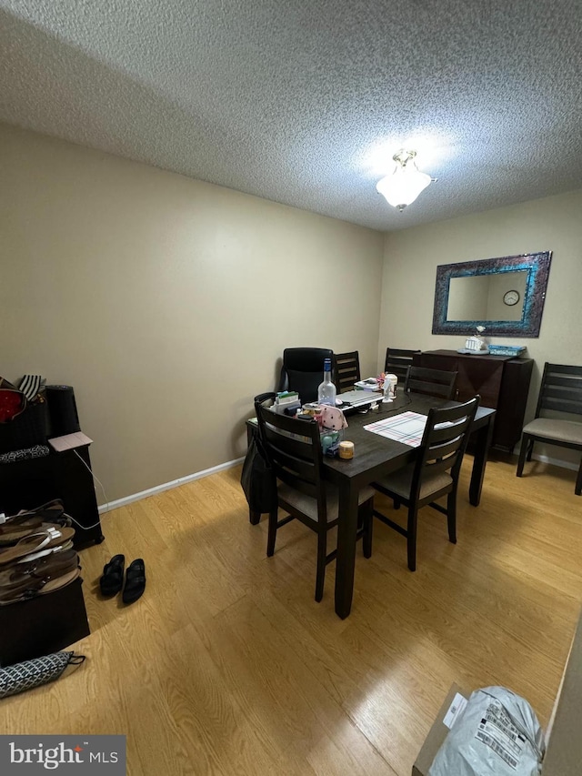 office area with a textured ceiling and hardwood / wood-style floors