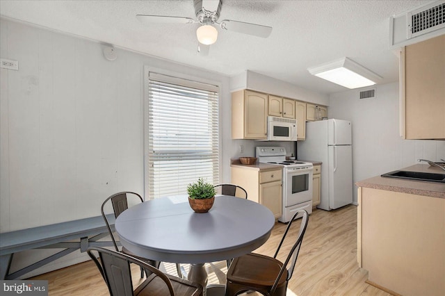 kitchen featuring sink, white appliances, ceiling fan, and light hardwood / wood-style flooring