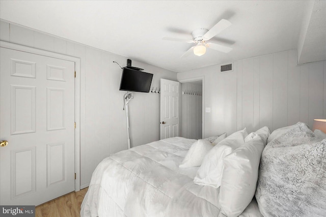 bedroom with ceiling fan and light hardwood / wood-style floors