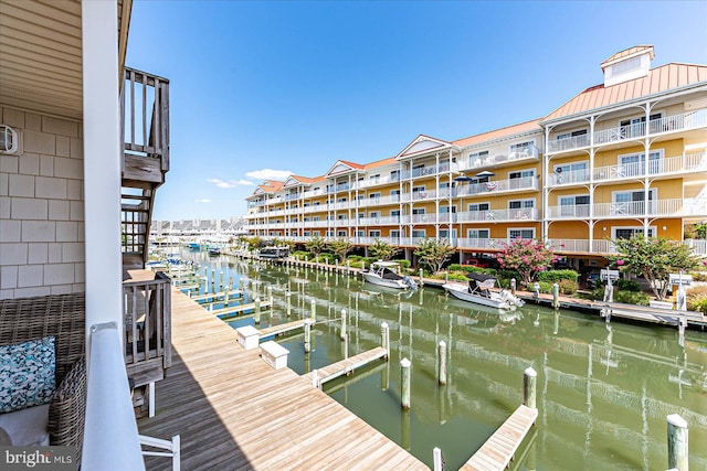 dock area with a balcony and a water view