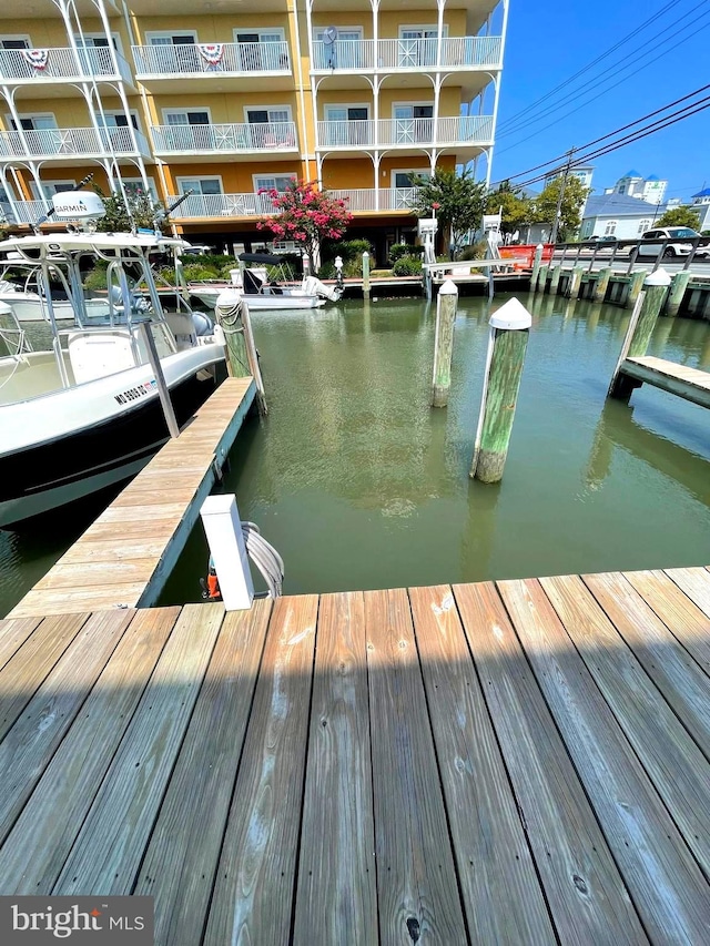 dock area featuring a balcony and a water view