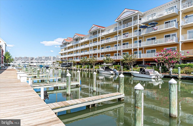 dock area with a balcony and a water view