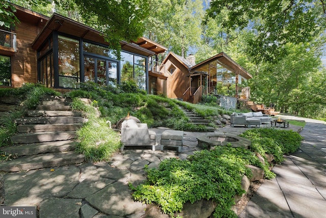 view of front facade with an outdoor living space and a patio area