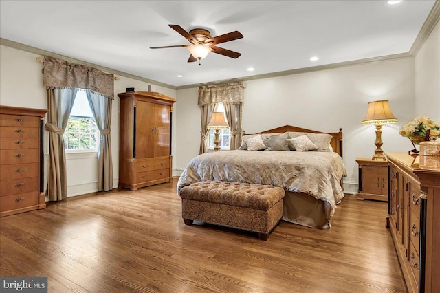 bedroom with light wood finished floors and crown molding