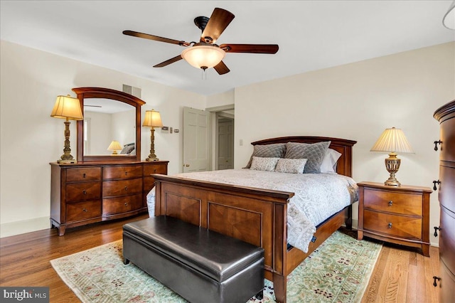 bedroom featuring dark wood-type flooring, ceiling fan, and baseboards