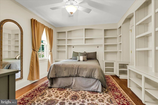 bedroom with baseboards, dark wood finished floors, and a ceiling fan