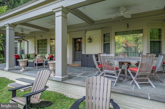 deck with outdoor lounge area, ceiling fan, and a patio