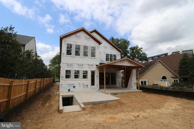 back of property with a patio area and fence