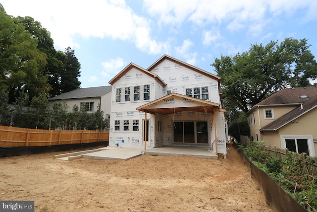 back of property featuring a patio and fence