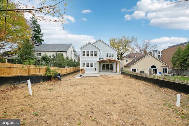 rear view of house with a patio area and a fenced backyard